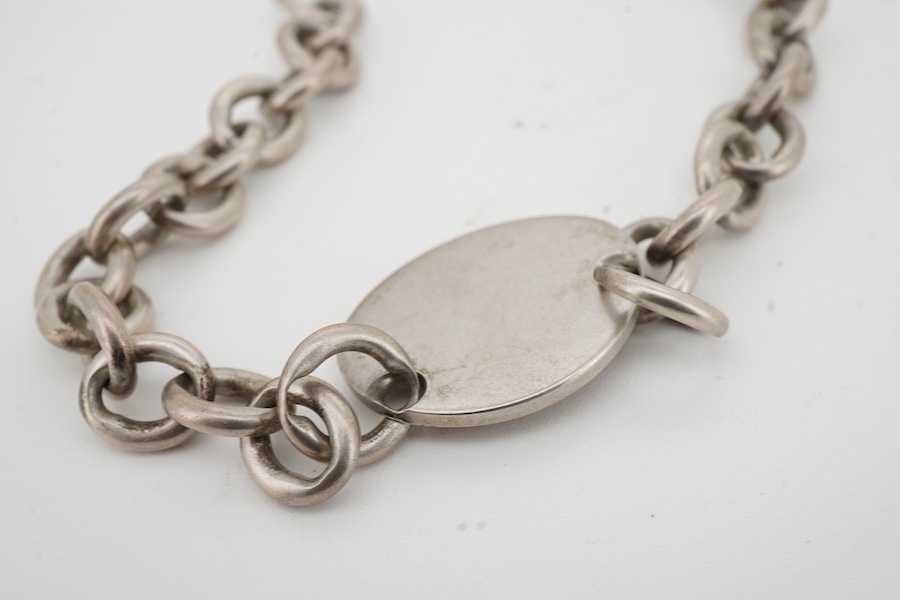 Tiffany & Co, a silver 'Return to Tiffany' bracelet, circa 2006, the oval plaque reading 'Please Return to Tiffany & Co. New York 925' on a belcher link chain, in silver, length 21.5cm, British hallmarks for silver, make
